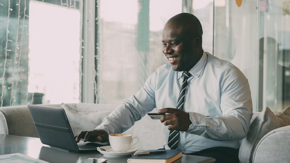 Professional using laptop and credit card for digital payment — representing fintech and digital financial services